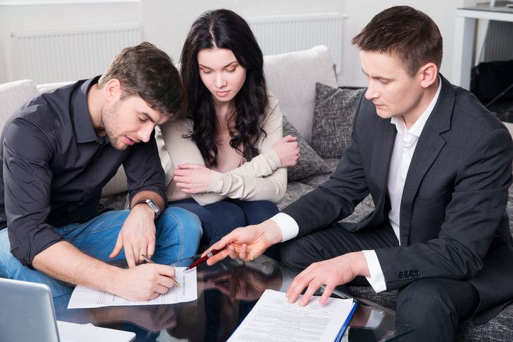 couple signing legal contract lawyer